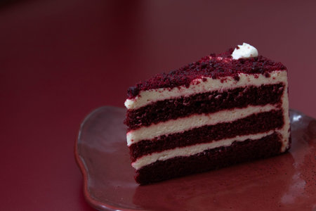 Red velvet cake on a red background. Selective focus with shallow depth of field.