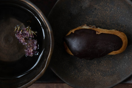 Tasty Chocolate eclair, a crispy choux pastry filled with chocolate pastry cream , on Black Backgroundの写真素材