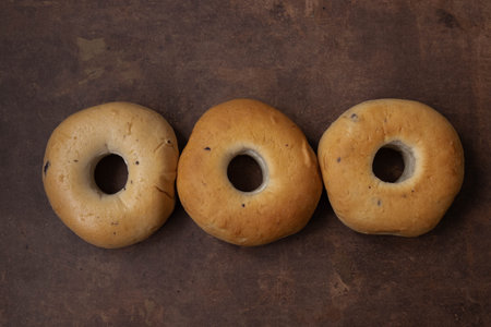 three bagels on a rustic background, top view, close-up