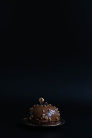 Chocolate cake with nuts on a black background. Copy space.の写真素材