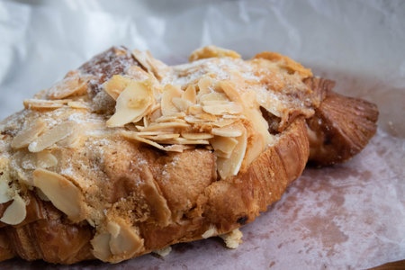 Croissant with almonds on a white background. Selective focus.