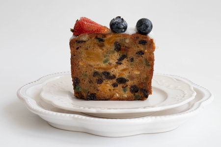 Fruit cake with strawberries, blueberries and raisins on a white backgroundの写真素材