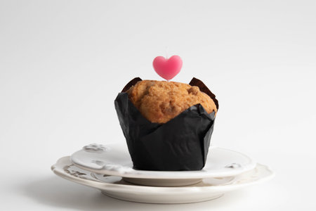 Muffin with heart shaped candle on white background. Valentines dayの写真素材