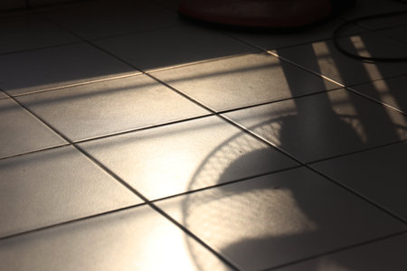 a shadow of an electric fan on the floor at at sun downの写真素材