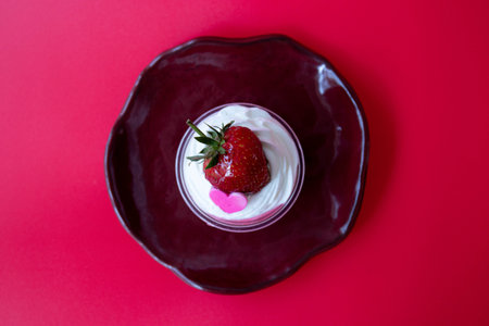 Strawberry jelly topped with white whip cream and Fresh Strawberry with Pink Heart, Red Backgroundの写真素材