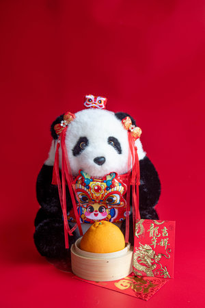 Panda Doll and A basket of Fresh Orange on Red Backgroundの写真素材