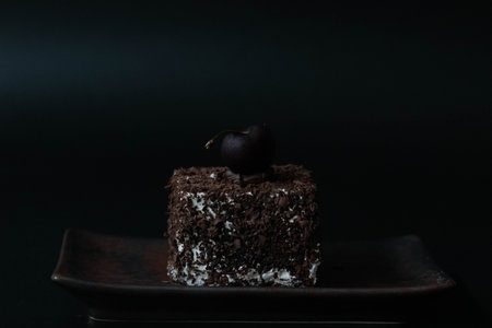 Chocolate cake with cherry on a black background. Selective focus.の写真素材