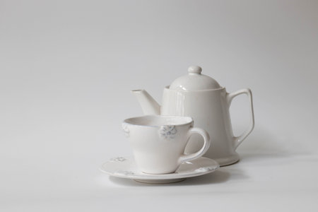Teapot and cup of tea on a white background, isolatedの写真素材