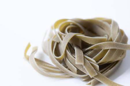close up of fresh raw fettuccine pasta on white backgroundの写真素材