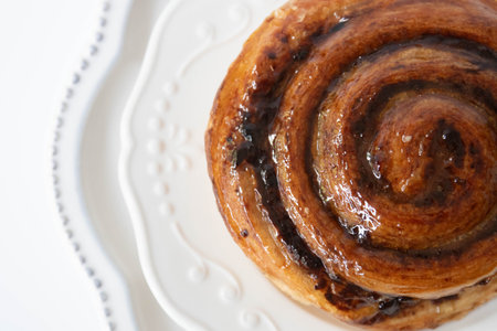 Homemade cinnamon buns on a white plate. Selective focus.