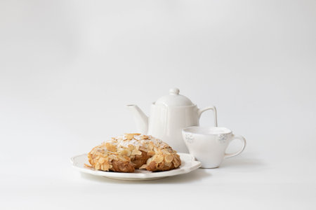 Cake and teapot on a white background with copy spaceの写真素材