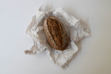 Rye bread on crumpled paper isolated on white background.
