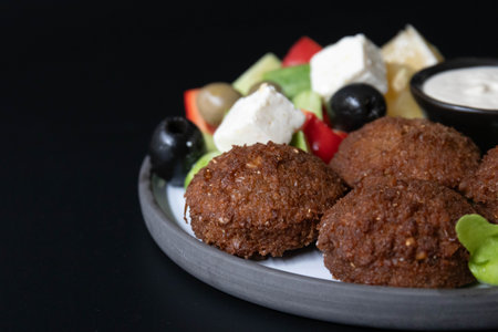 Fried falafel with salad on black background.の写真素材