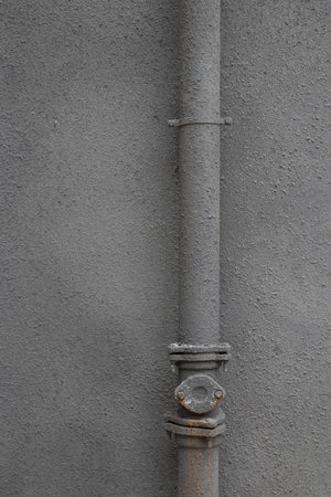 Pipe on a gray wall. Close-up. Texture.の写真素材