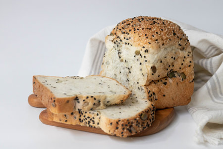 Bread with black sesame and sunflower seeds on white backgroundの写真素材