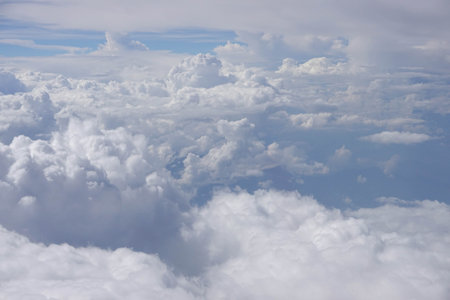 Clouds and sky as seen through window of an aircraft during flight