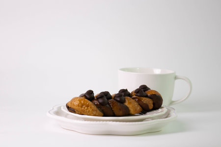 Cup of coffee and cookies with chocolate chips on a white background