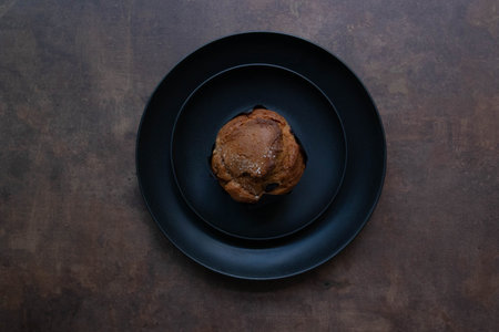golden-brown muffins sit on a wooden board.の写真素材