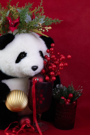 Panda bear with christmas decoration on red background, stock photoの写真素材