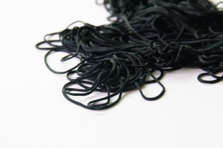 Black nylon rope isolated on white background. Clipping path included.