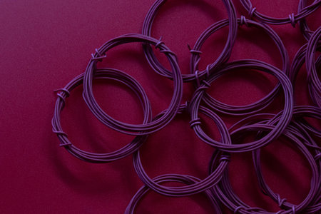 Purple rubber bands on a red background. Close-up.の写真素材