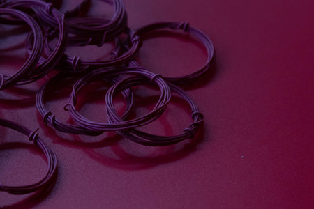 Purple rubber bands on a red background. Close-up.の写真素材