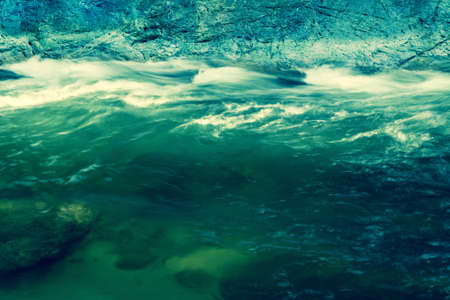 Stream of water through the rocks from little waterfall , soft focus with filter effectの写真素材