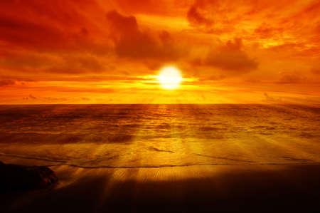Morning sunrise at sea with  golden sky backgroundの写真素材