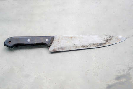 old  knife on gray concrete wallの写真素材