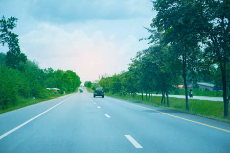 Highway road   in Thailland  with green tree aroundの写真素材