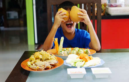cute Asian boy with food  and fruitのeditorial素材