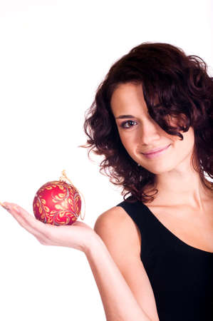 Beautiful smiling girl with Christmas ball on white backgroundの写真素材