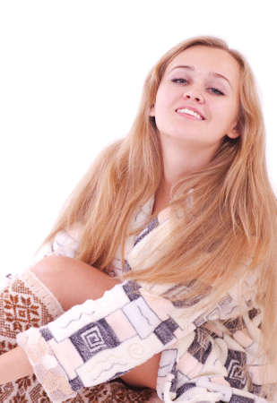 Young woman in a plush bathrobe against a white backgroundの写真素材