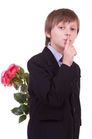 Little beautiful boy with pink roses on white backgroundの写真素材
