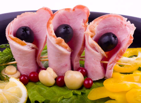 Tasty bacon rolls with olive and pepper on the plate