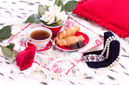 Beautiful romantic breakfast with gifts and rose on a bedの写真素材