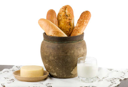 Beautiful bread set with milk and cheese on white background