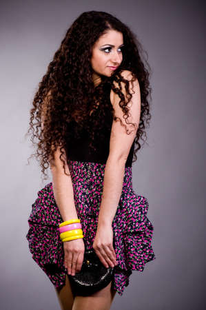 Portrait of the beautiful nice woman with long ringlets hair