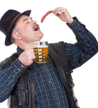 Elderly man holding a beer belly and sausage on white backgroundの写真素材