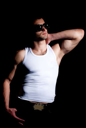 Fashionable muscular man in a fashion poseの写真素材