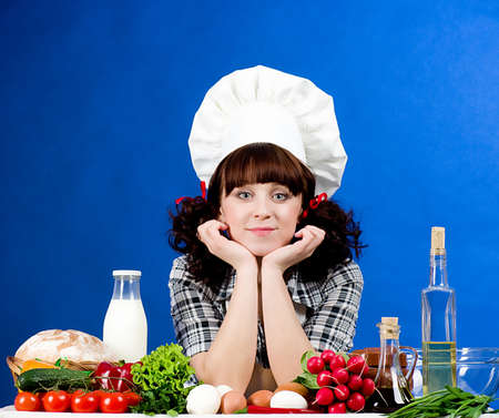 Smiling happy cook woman with food ingredients