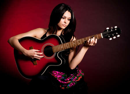 Carmen beautiful woman with guitar on dark backgroundの写真素材