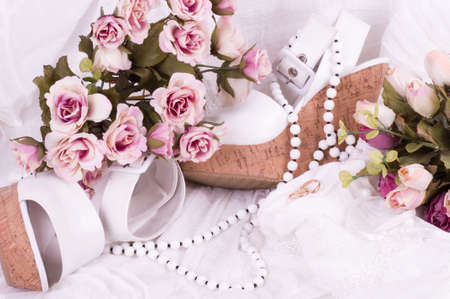 Vintage lace with flowers, shoe and wedding rings on white background の写真素材