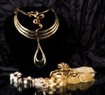 Golden jewelry on black background