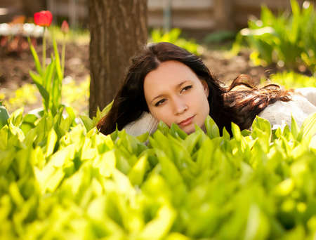 Beautiful woman in spring green lilies of the valleyの写真素材