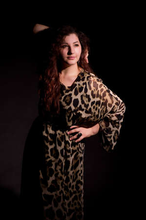 Sexy young woman in fashion dress on dark background の写真素材