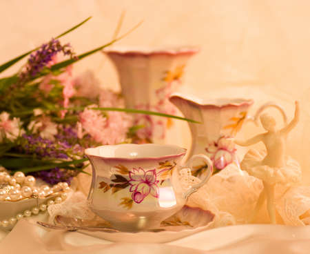 Vintage tea in elegant cups and flowersの写真素材