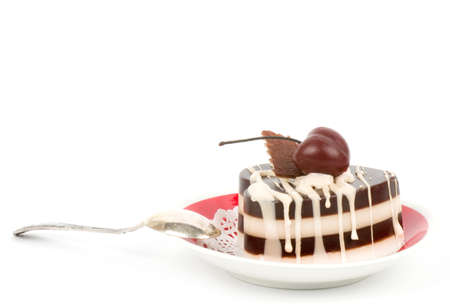 Dessert - sweet cake with cherry on a plate on backgroundの写真素材