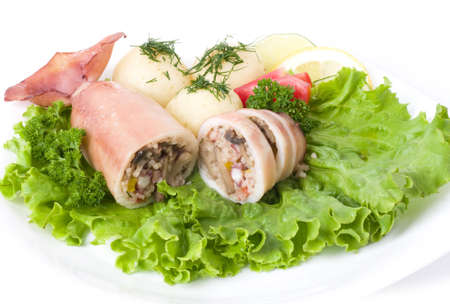 Squid stuffed with shrimp and vegetables on salad leafの写真素材