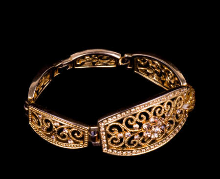 Golden jewelry on black backgroundの写真素材